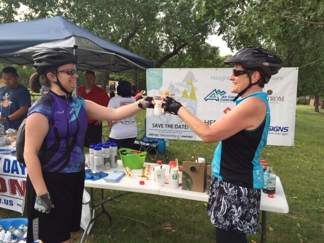 Two femail riders enjoying Bike To Work day with Air Care Colorado